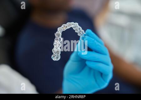 Dental aesthetic clinic worker holding clear aligners to straight teeth Stock Photo