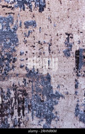 Texture of a beige-blue carpet with an abstract pattern, close-up. Vertical image. Stock Photo