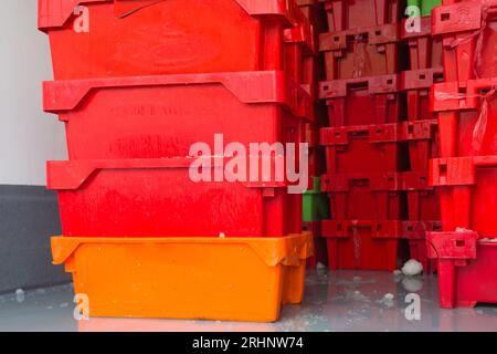 plastic crates or packing cases stacked with fresh fish in a refrigerated truck concept fishing industry and logistics Stock Photo