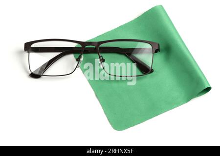 Glass cleaning green cloth napkin with a pair of glasses over it, composition isolated on white background. High resolution photo. Full depth of field Stock Photo