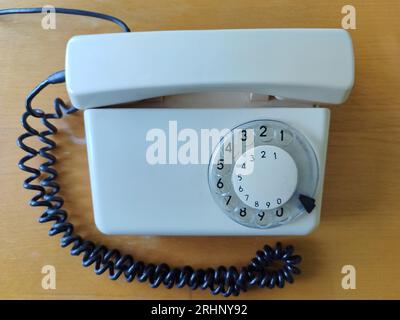 Top view of white old phone on office. Concept of obsolete technology Stock Photo