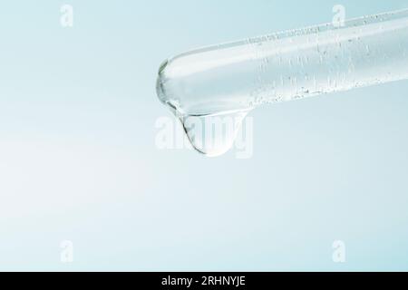 Pipette dropping liquid into glass tubes. Laboratory glassware with dropper into test tube close up macro.. laboratory equipment glassware. Concept of Stock Photo