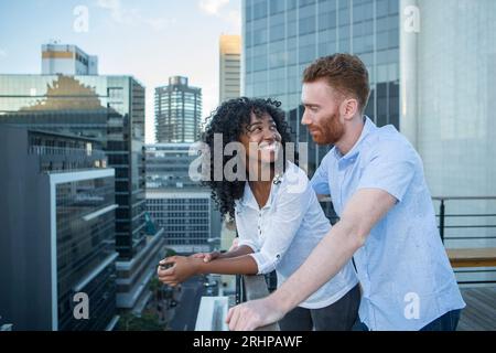 Couple against big city backdrop Stock Photo
