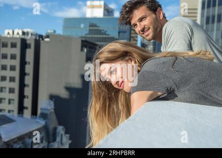 Couple against big city backdrop Stock Photo