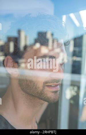 Man looks at the window Stock Photo