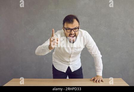 Angry young man pointing his finger at the camera, shouting at you and blaming you Stock Photo