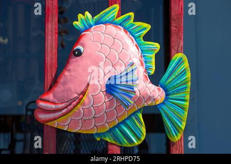 Naples, Florida, USA. Colourful cartoon fish ornament attached to wooden balcony of the Shell Shack, a popular souvenir and gift shop. Stock Photo