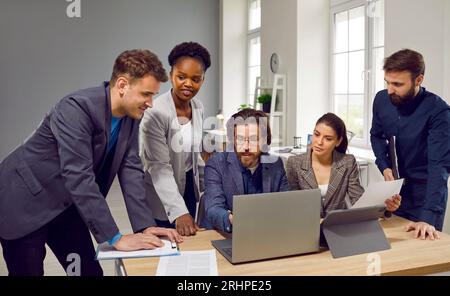 Teamwork of multiracial people working in progressive company on preparation of new business project Stock Photo