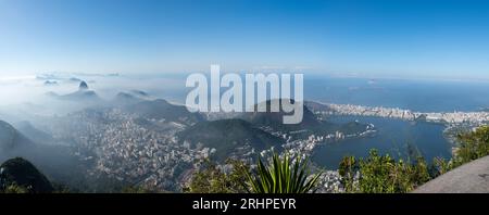 Rio de Janeiro: stunning view of the city in the morning mist from the Christ the Redeemer on Mount Corcovado with Sugarloaf Mountain, beaches, lagoon Stock Photo