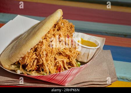 Venezuelan arepa stuffed with chicken as served in Queens, NY, USA Stock Photo