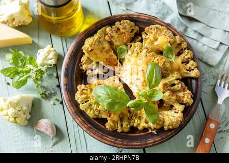 Healthy eating, plant based meat substitute concept.Vegetarian organic food. Baked cauliflower steaks with herbs and spices on a wooden table. Stock Photo