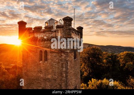 Germany, Thuringia, Suhl, sunrise next to Domberg tower, forest, back light Stock Photo