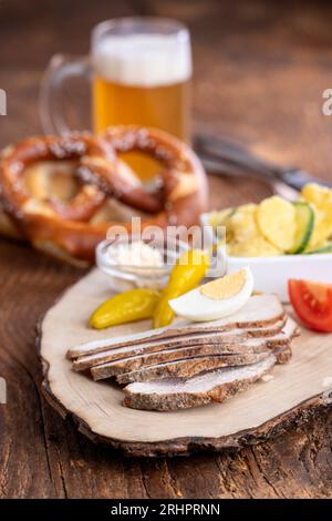 bavarian cold pork slices with pretzel Stock Photo