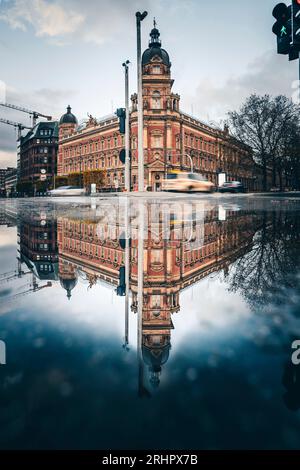 Enchanted reflection, historic Hamburg house facade reflected in puddle Stock Photo