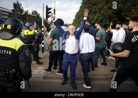 THE HAGUE - A counter-demonstration of Muslims against the demonstration of Pegida leader Edwin Wagensveld who tore up a Koran during a protest by anti-Islam movement Pegida in front of the Turkish embassy. Quran burnings in Denmark and Sweden caused a lot of social unrest there. ANP RAMON VAN FLYMEN netherlands out - belgium out Stock Photo