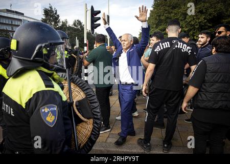 THE HAGUE - A counter-demonstration of Muslims against the demonstration of Pegida leader Edwin Wagensveld who tore up a Quran during a protest by anti-Islam movement Pegida in front of the Turkish embassy. Quran burnings in Denmark and Sweden caused a lot of social unrest there. ANP RAMON VAN FLYMEN netherlands out - belgium out Stock Photo