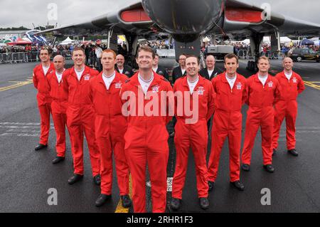 Red Arrows team of 2012 posing with Avro Vulcan bomber & crew at Farnborough International Airshow, UK. Team leader Squadron Leader Jim Turner, Red 1 Stock Photo