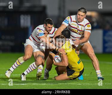Greg Eden #2 of Castleford Tigers /tackled by Tom Lineham #5 of Wakefield Trinity during the Betfred Super League Round 22 match Wakefield Trinity vs Castleford Tigers at The Be Well Support Stadium, Wakefield, United Kingdom, 18th August 2023 (Photo by Craig Cresswell/News Images) in, on 8/18/2023. (Photo by Craig Cresswell/News Images/Sipa USA) Credit: Sipa USA/Alamy Live News Stock Photo