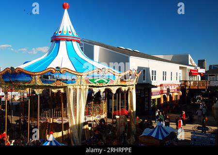 The Carousel at Fisherman's Wharf in San Francisco is a popular attraction for families with a merry go round carousel and retail stores Stock Photo