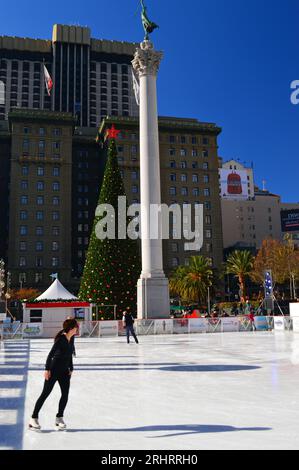 A young woman ice skates during the Christmas season in Union Square in San Francisco on an outdoor rink Stock Photo