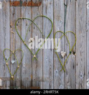 hearts made of willow branches on a wooden wall Stock Photo