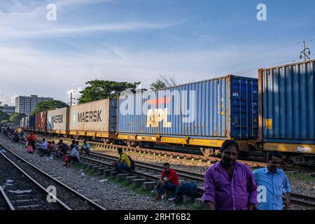 A shipping container trail cross the Airport Railway Station in Dhaka ...