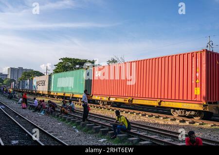 A shipping container trail cross the Airport Railway Station in Dhaka ...