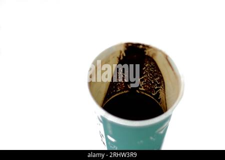 A drunk cup of Turkish coffee in a disposable drinking foam cup isolated on a white background, with text of coffee time, love and Eiffel tower on it, Stock Photo