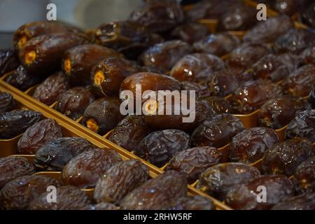 A pile of appetizing dried date medjool fruits placed on stall in local market Stock Photo
