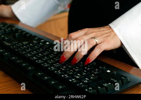 working office lady finger on computer or laptop black keyboard in close up Stock Photo
