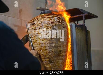 Meat trompo for tacos al pastor. Mexican street food. Marinated meat al pastor. Stock Photo