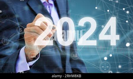 Business man touching screen with 2024 writing Stock Photo