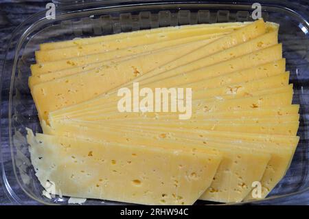 Slices of Egyptian Rumi cheese, also called gebna romiya or gebna turkiya, Roumi, Romi also Romy, middle Eastern parmesan hard cheese, has a pungent s Stock Photo