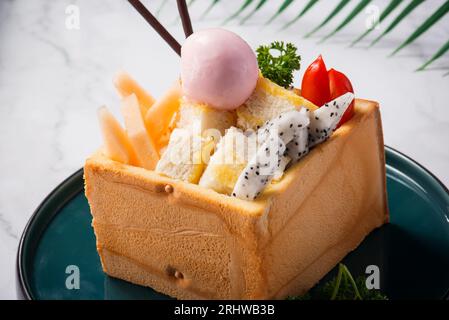 Honey toast and ice cream with Mixed Fruit on bread. Stock Photo