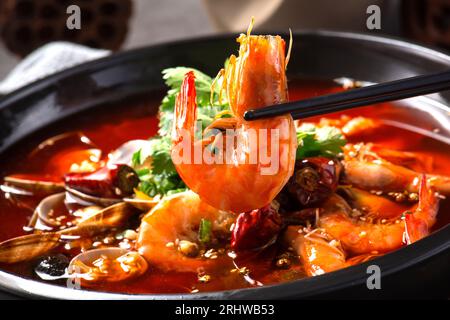 Close up of a popular Chinese Sichuan province cuisine Sliced Duck Blood in Chili Sauce oil with lunch meat, tripe and seafood (Chinese: Maoxuewang) Stock Photo