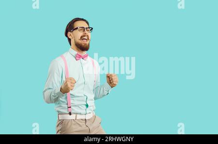 Happy excited emotional man sincerely rejoices at his luck isolated on light blue background. Stock Photo