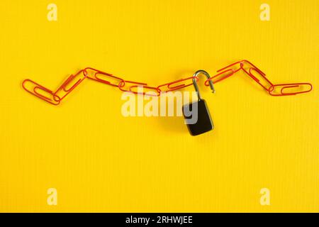 business concept, threat to internet security,protection of data or digital asset against unauthorized accesswith chain of paper clips and open lock Stock Photo