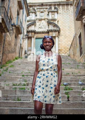 Young female posing for a photo in a landmark building in Girona Spain Stock Photo