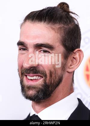 Former competitive swimmer Michael Phelps, left, HDRF founder & chairman  Audrey Gruss and husband Martin Gruss pose together at the Hope for  Depression Research Foundation's 15th annual HOPE luncheon at the Plaza