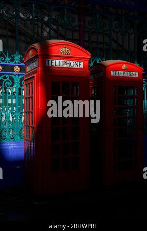 A row of two historic red phone boxes in Smithfield Meat Market - the smaller of them is the K6 design and the other is the K2 design, both created by Stock Photo