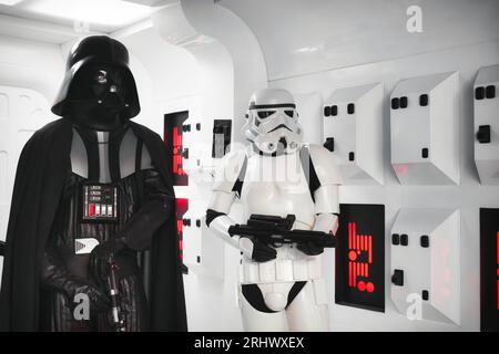 20 May 2023, St. Julians - Malta: Darth Vader and a stormtrooper from the Star Wars movie in full body armor suit costume standing in a spaceship back Stock Photo