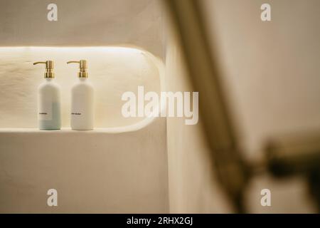 Selective focuse of Pump glass bottle with Liquid soap, shampoo, bath foam and accessories in bathroom. Stock Photo
