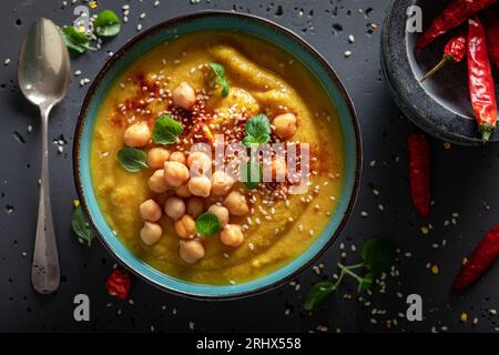 Green chickpea soup with hot chilli pepper and sesame seeds. Spicy soup made of chickpea and chilli pepper. Stock Photo