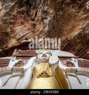 Buddha statue with carvings in Kaw Goon cave in Myanmar. Stock Photo