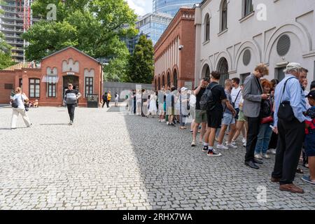 Warsaw, Poland - August 1, 2023. Lots of people are queuing outside to get in. Museum of the Warsaw Uprising. Sight. Historical Polish monument. Outdoor Muzeum Powstania Warszawskiego. Queue street Stock Photo
