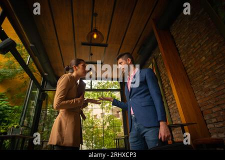 A cute business people are talking to each other after they are done with their work. They are leaving home Stock Photo