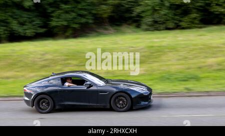 Woburn, Beds, UK - Aug 19th 2023: 2018 black F type Jaguar  car travelling on an English country road. Stock Photo