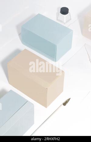 High angle of composition with tea boxes, a writing pen and ink against white background Stock Photo