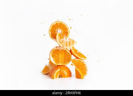 Fresh juicy sliced oranges with droplets and a white background Stock Photo