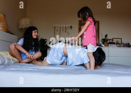 children playing in the bedroom of parents on big bed Stock Photo